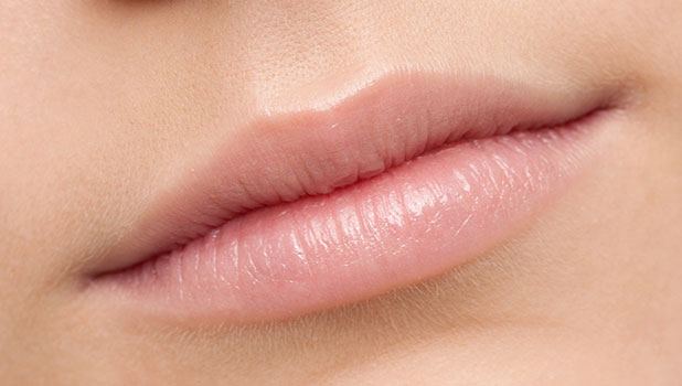 Close-up of a person's smooth natural pink lips